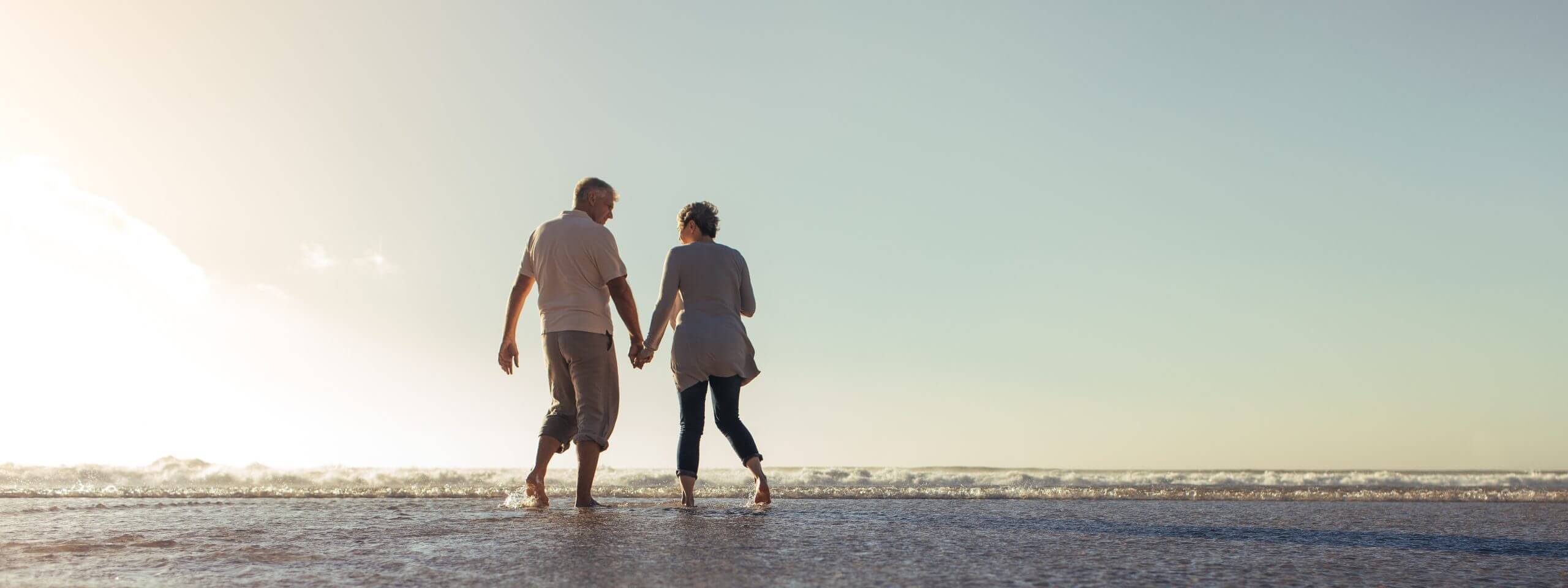 A happy couple walking on the sea shore